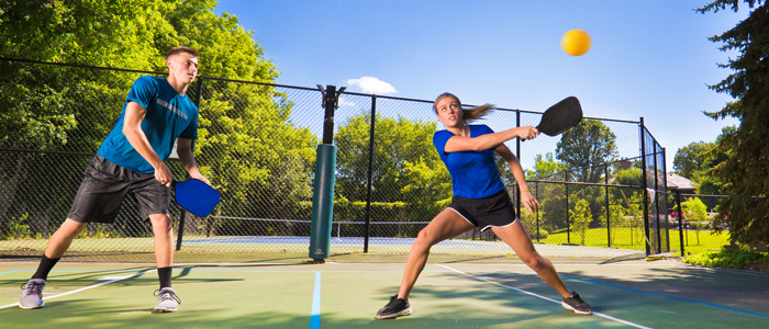 Man and Woman playing Pickleball