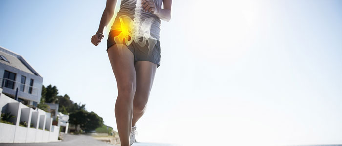 Woman running with hip highlighted in pain